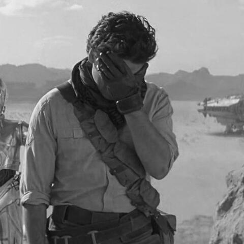a black and white photo of poe dameron from star wars looking right.