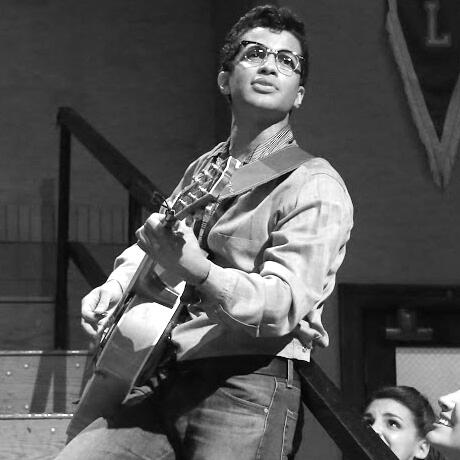 a black and white photo of doody delfuego from grease live looking right.