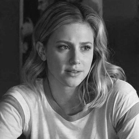 a black and white photo of betty cooper from riverdale looking right.