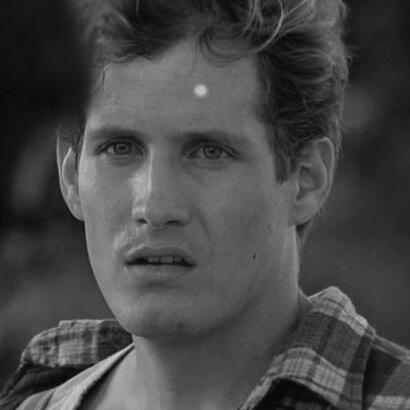 a black and white photo of tommy jarvis from friday the 13th looking left.