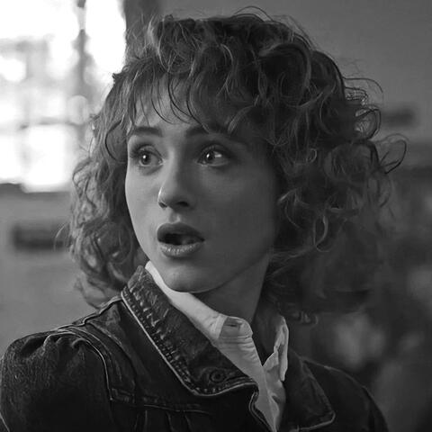 a black and white photo of nancy wheeler from stranger things looking left.