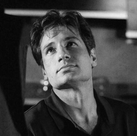 a black and white photo of fox mulder from the x-files looking left.