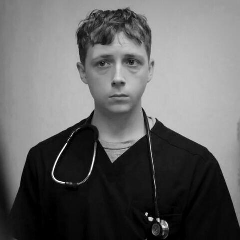 a black and white photo of dennis whitaker from the pitt looking slightly to the left.