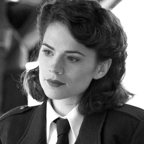 a black and white photo of peggy carter from captain america looking left.